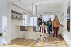 Male real estate agent showing house to family