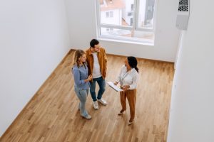 A couple is visiting a house for rental evaluation together with the real estate agent.