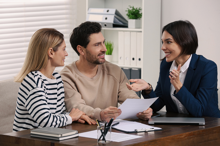 The landlady having a conversation with the tenants to retain them and encourage renewals.