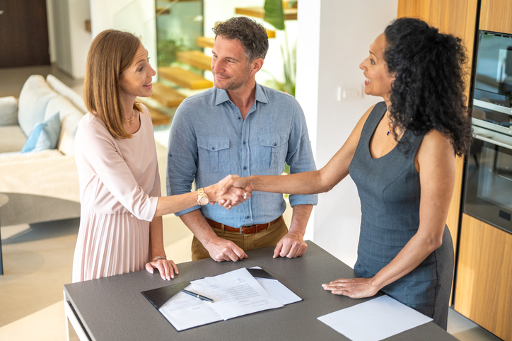 A landlady collecting security deposits from her tenants.