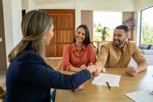A couple and a real estate agent having a conversation for GIL's Guide to Alberta's landlord-tenant laws in 2025.