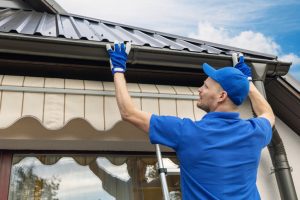 A professional property maintenance technician inspects a rental house to safeguard and prepare it for Alberta's changing seasons.