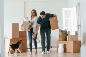 A couple moving into their new rental property that allows pets.