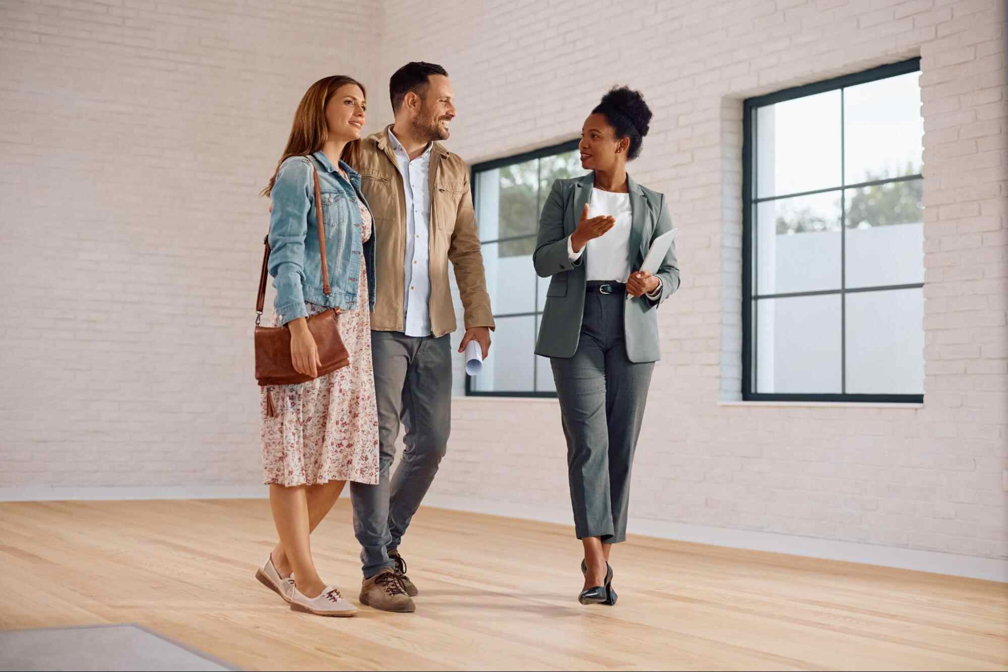 Property manager guiding rental owners through a property while discussing how to find a management company for a property.